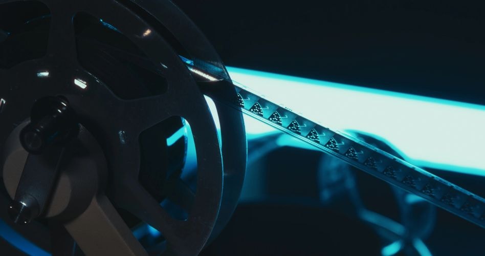 Moody film projector glowing in blue light — atmospheric design imagery
